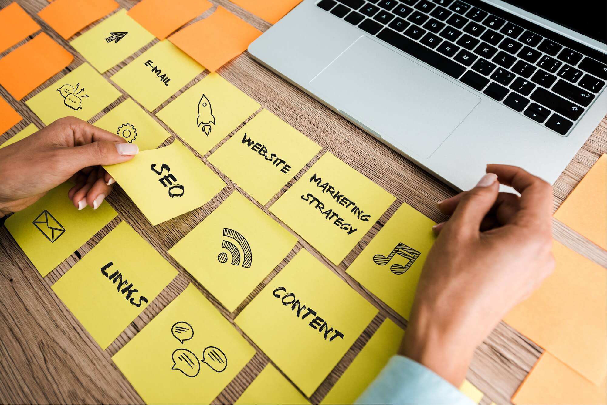 cropped view of woman touching sticky note with seo lettering near laptop on desk - Social Media Marketing: How to Build Your Brand on Social