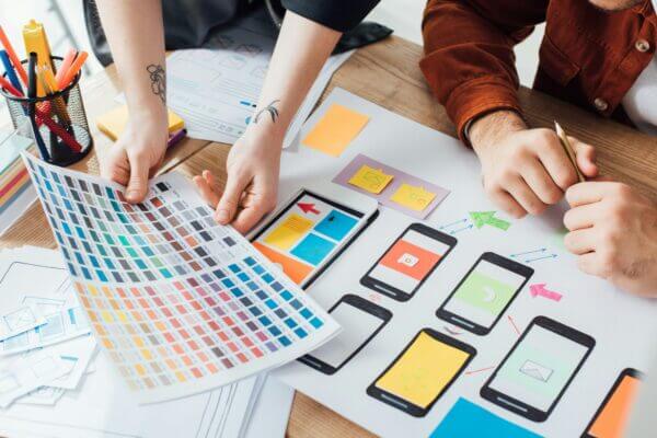 cropped view of designers planning user experience design with color palette and website sketches on 600x400 - 5 Warning Signs Your Website Desperately Needs a Redesign